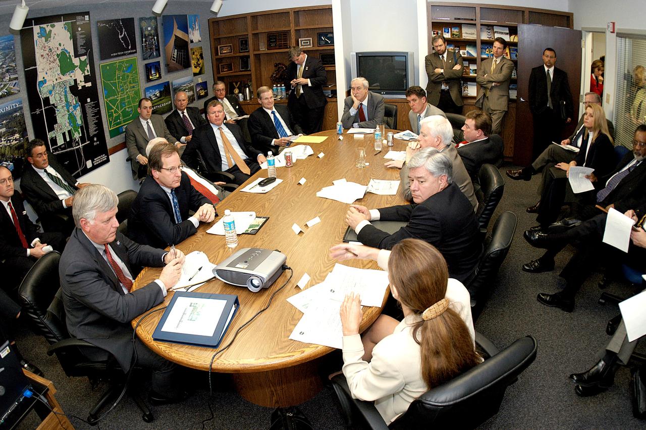 KENNEDY SPACE CENTER, FLA. - NASA and government officials are gathered to hear about the assets of the Central Florida Research Park, near Orlando, as the site of NASA’s new Shared Services Center.  Six sites around the U.S. are under consideration.  At the far end is NASA Administrator Sean O’Keefe.  He is flanked, on the left, by Florida Congressman Tom Feeney and U.S. Senator Bill Nelson; and on the right by U.S. Congressman Dave Weldon and U.S. Representative Ric Keller.  In the foreground, at left, is Center Director Jim Kennedy.  At right is  Pamella J. Dana, Ph.D., director, Office of Tourism, Trade, and Economic Development in Florida.  The center would centralize NASA’s payroll, accounting, human resources, facilities and procurement offices that are now handled at each field center.  The consolidation is part of the One NASA focus.