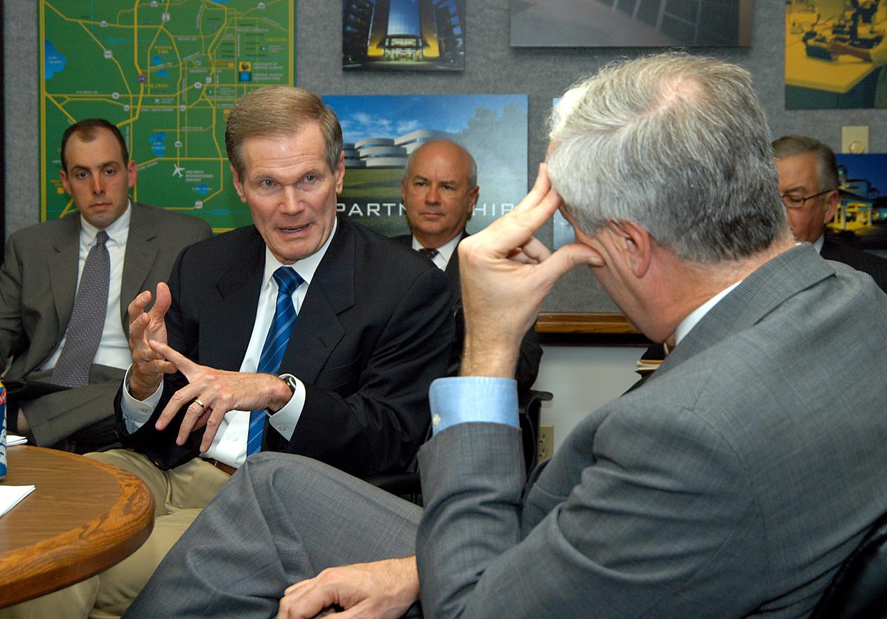 KENNEDY SPACE CENTER, FLA. - U.S. Senator Bill Nelson (center) makes a point while talking to NASA Administrator Sean O’Keefe (right) about the assets of the Central Florida Research Park, near Orlando, as the site of NASA’s new Shared Services Center. Six sites around the U.S. are under consideration for location of the Center, which would centralize NASA’s payroll, accounting, human resources, facilities and procurement offices that are now handled at each field center.  The consolidation is part of the One NASA focus.  Others attending the presentation included Congressman Tom Feeney, Congressman Dave Weldon, U.S. Representative Ric Keller, Center Director Jim Kennedy and Pamella J. Dana, Ph.D., director, Office of Tourism, Trade, and Economic Development in Florida.