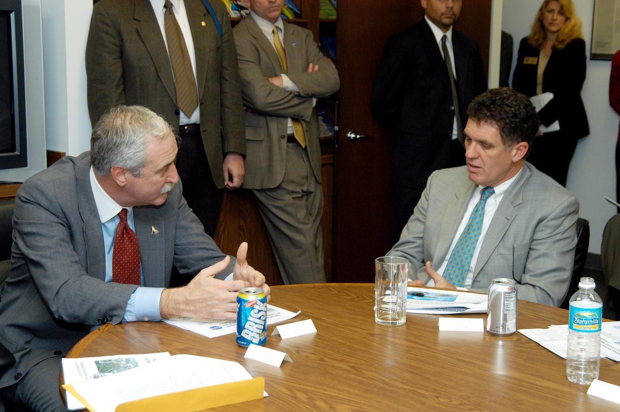 KENNEDY SPACE CENTER, FLA. - NASA Administrator Sean O’Keefe (left) talks with Congressman Dave Weldon (right) after a presentation about the assets of the Central Florida Research Park, near Orlando, as the site of NASA’s new Shared Services Center. Six sites around the U.S. are under consideration for location of the Center, which would centralize NASA’s payroll, accounting, human resources, facilities and procurement offices that are now handled at each field center.  The consolidation is part of the One NASA focus.  Others attending the presentation included Congressman Tom Feeney, U.S. Representative Ric Keller, U.S. Senator Bill Nelson, Center Director Jim Kennedy and Pamella J. Dana, Ph.D., director, Office of Tourism, Trade, and Economic Development in Florida.