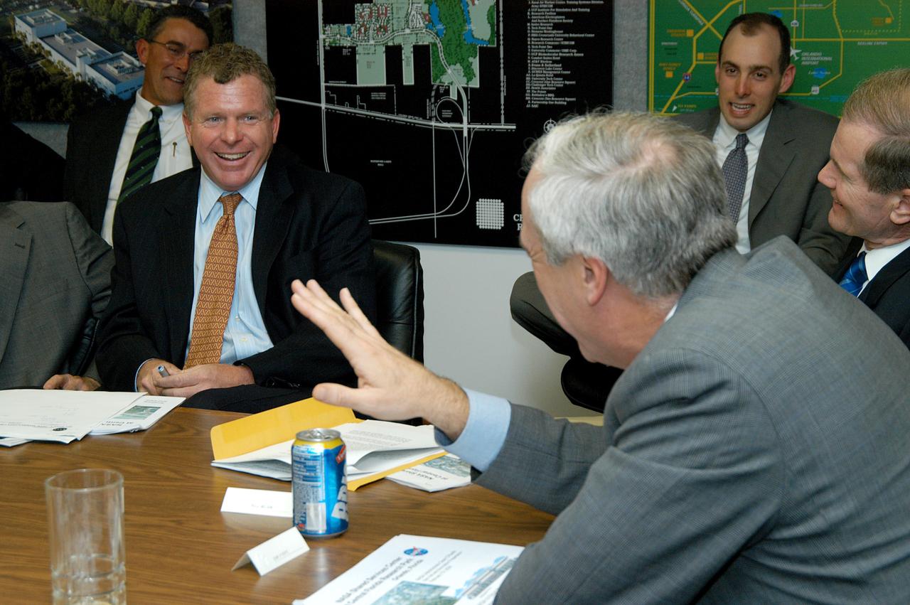KENNEDY SPACE CENTER, FLA. - After a presentation about the assets of the Central Florida Research Park, near Orlando, as the site of NASA’s new Shared Services Center, Congressmen Tom Feeney (center) and Dave Weldon (right) share a humorous moment with NASA Administrator Sean O’Keefe (foreground).  Six sites around the U.S. are under consideration for location of the Center, which would centralize NASA’s payroll, accounting, human resources, facilities and procurement offices that are now handled at each field center.  The consolidation is part of the One NASA focus.  Others attending the presentation included Congressman Dave Weldon, U.S. Representative Ric Keller, Center Director Jim Kennedy and Pamella J. Dana, Ph.D., director, Office of Tourism, Trade, and Economic Development in Florida.