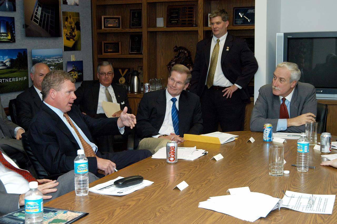 KENNEDY SPACE CENTER, FLA. - Congressman Tom Feeney (left) makes a point during a discussion around the table about the assets of the Central Florida Research Park, near Orlando, as the site of NASA’s new Shared Services Center.  At center is U.S. Senator Bill Nelson; at right is NASA Administrator Sean O’Keefe.  Six sites around the U.S. are under consideration for location of the Center, which would centralize NASA’s payroll, accounting, human resources, facilities and procurement offices that are now handled at each field center.  The consolidation is part of the One NASA focus.  Others attending the presentation included Congressman Dave Weldon, U.S. Representative Ric Keller, Center Director Jim Kennedy and Pamella J. Dana, Ph.D., director, Office of Tourism, Trade, and Economic Development in Florida.
