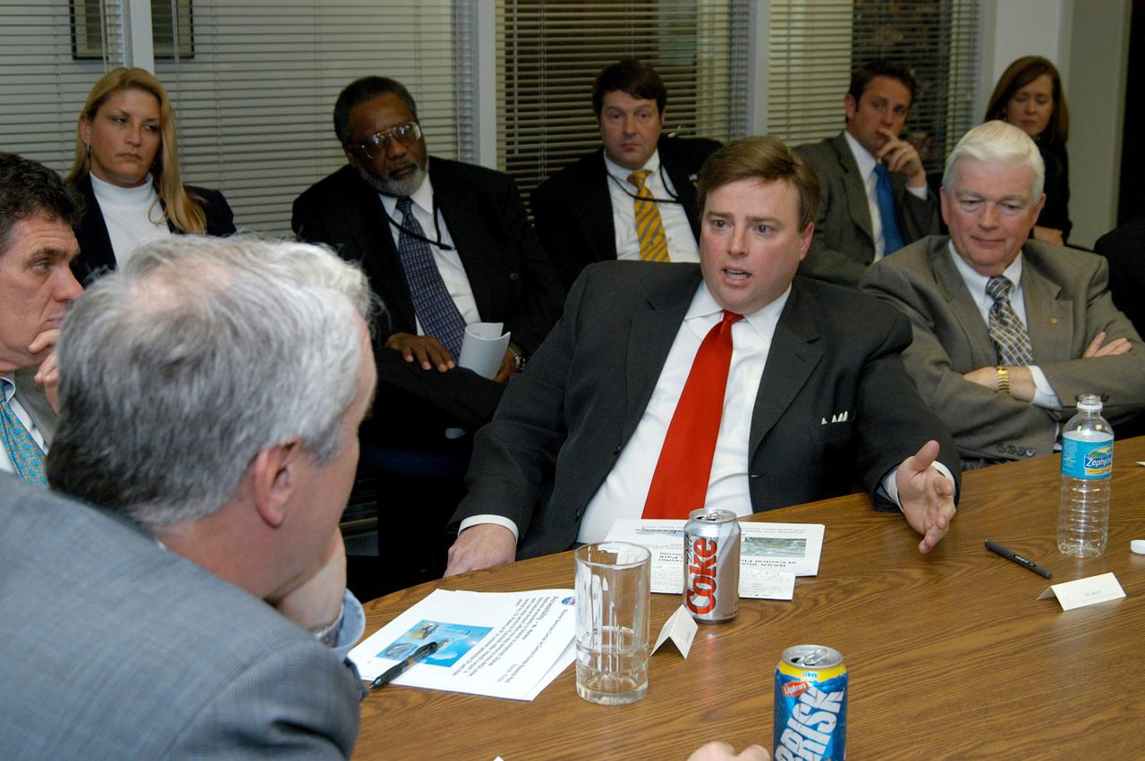 KENNEDY SPACE CENTER, FLA. - U.S. Representative Ric Keller (center) talks to NASA Administrator Sean O’Keefe (left foreground) about the assets of the Central Florida Research Park, near Orlando, as the site of NASA’s new Shared Services Center.  At left behind O’Keefe is Congressman Dave Weldon.  Six sites around the U.S. are under consideration for location of the Center, which would centralize NASA’s payroll, accounting, human resources, facilities and procurement offices that are now handled at each field center.  The consolidation is part of the One NASA focus.  The consolidation is part of the One NASA focus.  Others attending the presentation included Florida Congressman Tom Feeney, U.S. Senator Bill Nelson, Center Director Jim Kennedy and Pamella J. Dana, Ph.D., director, Office of Tourism, Trade, and Economic Development in Florida.