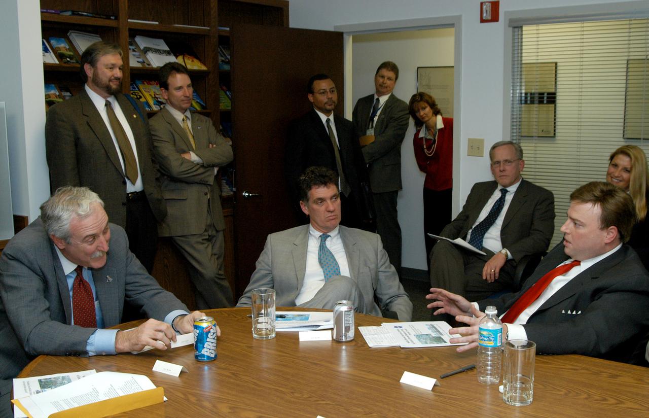 KENNEDY SPACE CENTER, FLA. - NASA Administrator Sean O’Keefe (left) talks to U.S. Representative Ric Keller across the table after a presentation about the assets of the Central Florida Research Park, near Orlando, as the site of NASA’s new Shared Services Center.  In the center is U.S. Congressman Dave Weldon.   Six sites around the U.S. are under consideration for location of the Center, which would centralize NASA’s payroll, accounting, human resources, facilities and procurement offices that are now handled at each field center.  The consolidation is part of the One NASA focus.  The consolidation is part of the One NASA focus.  Others attending the presentation included Florida Congressman Tom Feeney, Congressman Dave Weldon, U.S. Senator Bill Nelson, Center Director Jim Kennedy and Pamella J. Dana, Ph.D., director, Office of Tourism, Trade, and Economic Development in Florida.