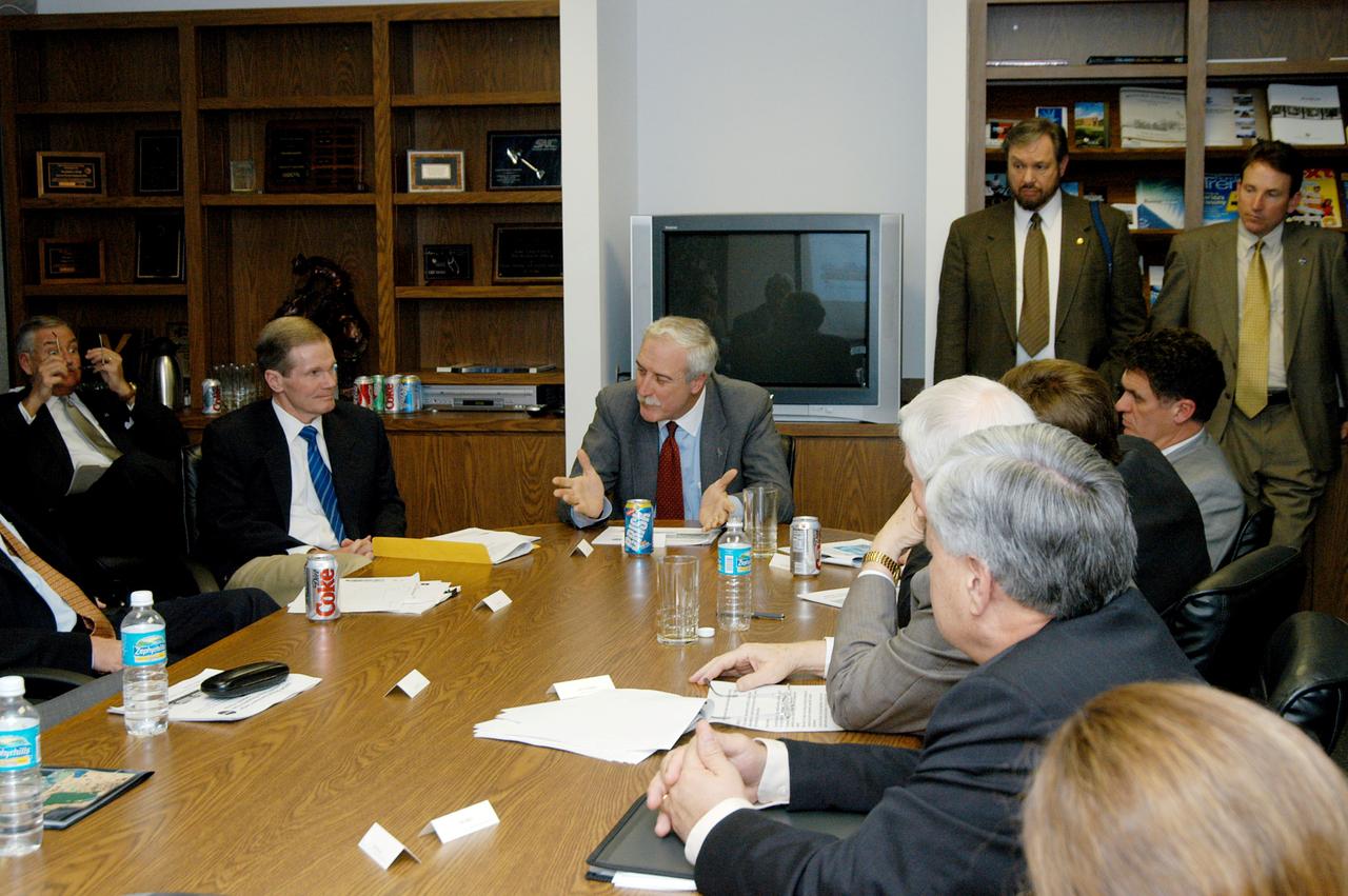 KENNEDY SPACE CENTER, FLA. - NASA Administrator Sean O’Keefe (center) talks to U.S. Senator Bill Nelson (left) after a presentation about the assets of the Central Florida Research Park, near Orlando, as the site of NASA’s new Shared Services Center. Six sites around the U.S. are under consideration for location of the Center, which would centralize NASA’s payroll, accounting, human resources, facilities and procurement offices that are now handled at each field center.  The consolidation is part of the One NASA focus.  Others attending the presentation included Florida Congressman Tom Feeney, Congressman Dave Weldon, U.S. Representative Ric Keller, Center Director Jim Kennedy and Pamella J. Dana, Ph.D., director, Office of Tourism, Trade, and Economic Development in Florida.