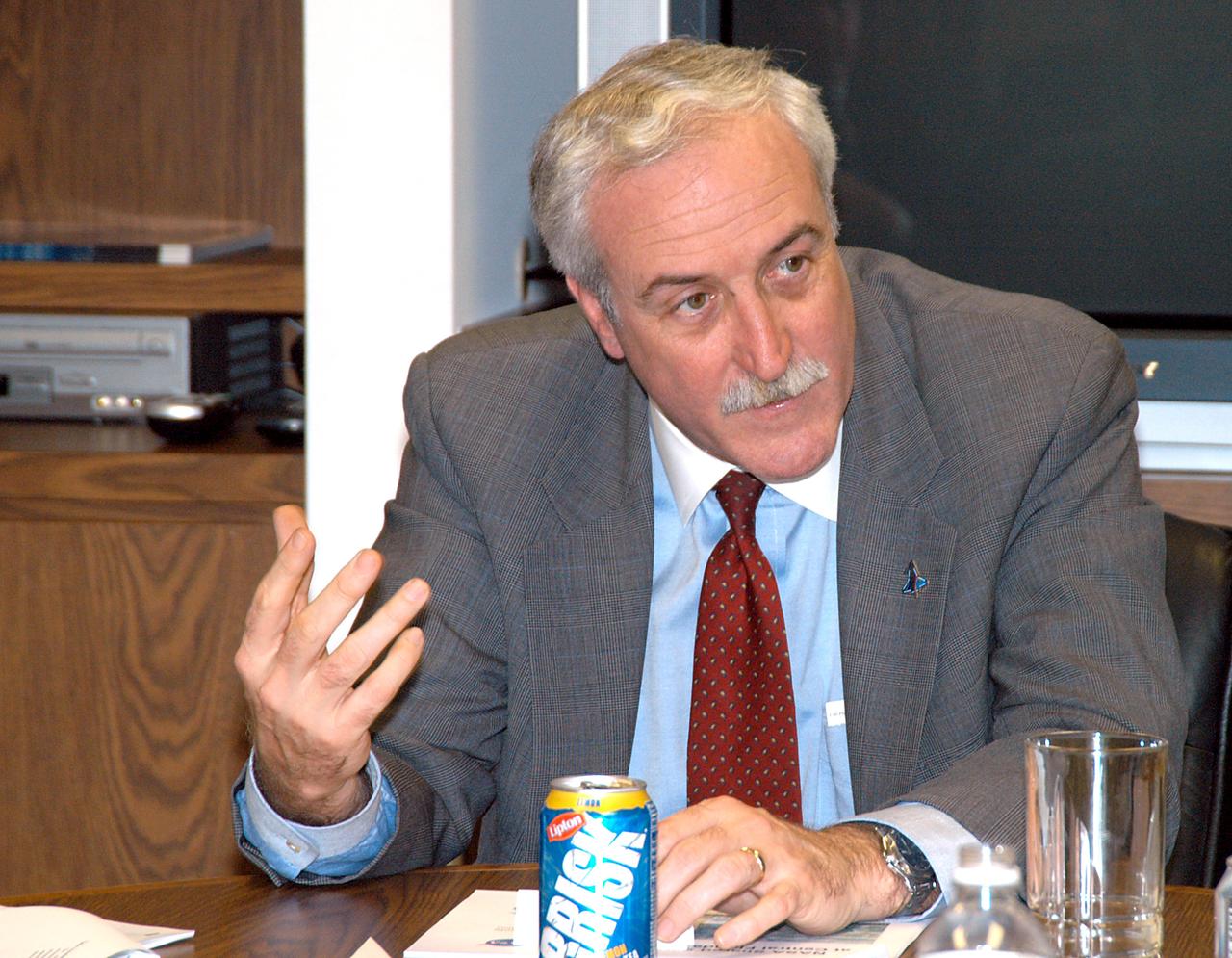 KENNEDY SPACE CENTER, FLA. - NASA Administrator Sean O’Keefe discusses the presentation about the assets of the Central Florida Research Park, near Orlando, as the site of NASA’s new Shared Services Center. Six sites around the U.S. are under consideration for location of the Center, which would centralize NASA’s payroll, accounting, human resources, facilities and procurement offices that are now handled at each field center.  The consolidation is part of the One NASA focus.  Others attending the presentation included Florida Congressman Tom Feeney, Congressman Dave Weldon, U.S. Representative Ric Keller, U.S. Senator Bill Nelson, Center Director Jim Kennedy and Pamella J. Dana, Ph.D., director, Office of Tourism, Trade, and Economic Development in Florida.