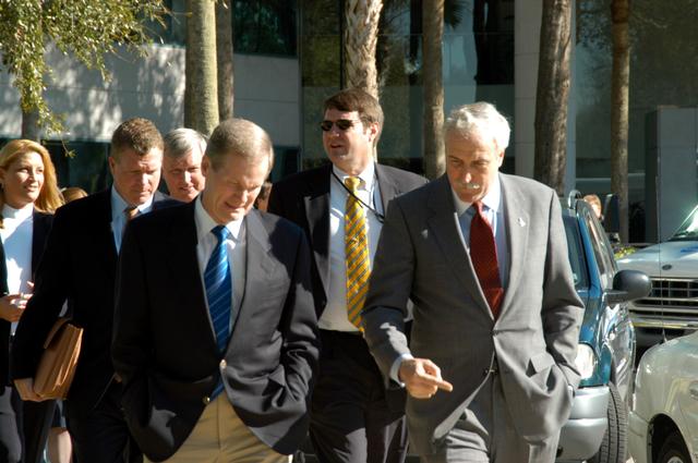 NASA image: KENNEDY SPACE CENTER, FLA. - U.S. Senator Bill Nelson (left foreground) and NASA Administrator Sean O’Keefe (right) look deep in conversation as they leave the Central Florida Research Park, near Orlando.  Behind Nelson is Congressman Tom Feeney and Center Director Jim Kennedy.  The research park is being proposed as the location for NASA’s new Shared Services Center. Six sites around the U.S. are under consideration for location of the Center, which would centralize NASA’s payroll, accounting, human resources, facilities and procurement offices that are now handled at each field center.  The consolidation is part of the One NASA focus.  Others attending the presentation included U.S. Representative Ric Keller, Congressman Dave Weldon and Pamella J. Dana, Ph.D., director, Office of Tourism, Trade, and Economic Development in Florida.