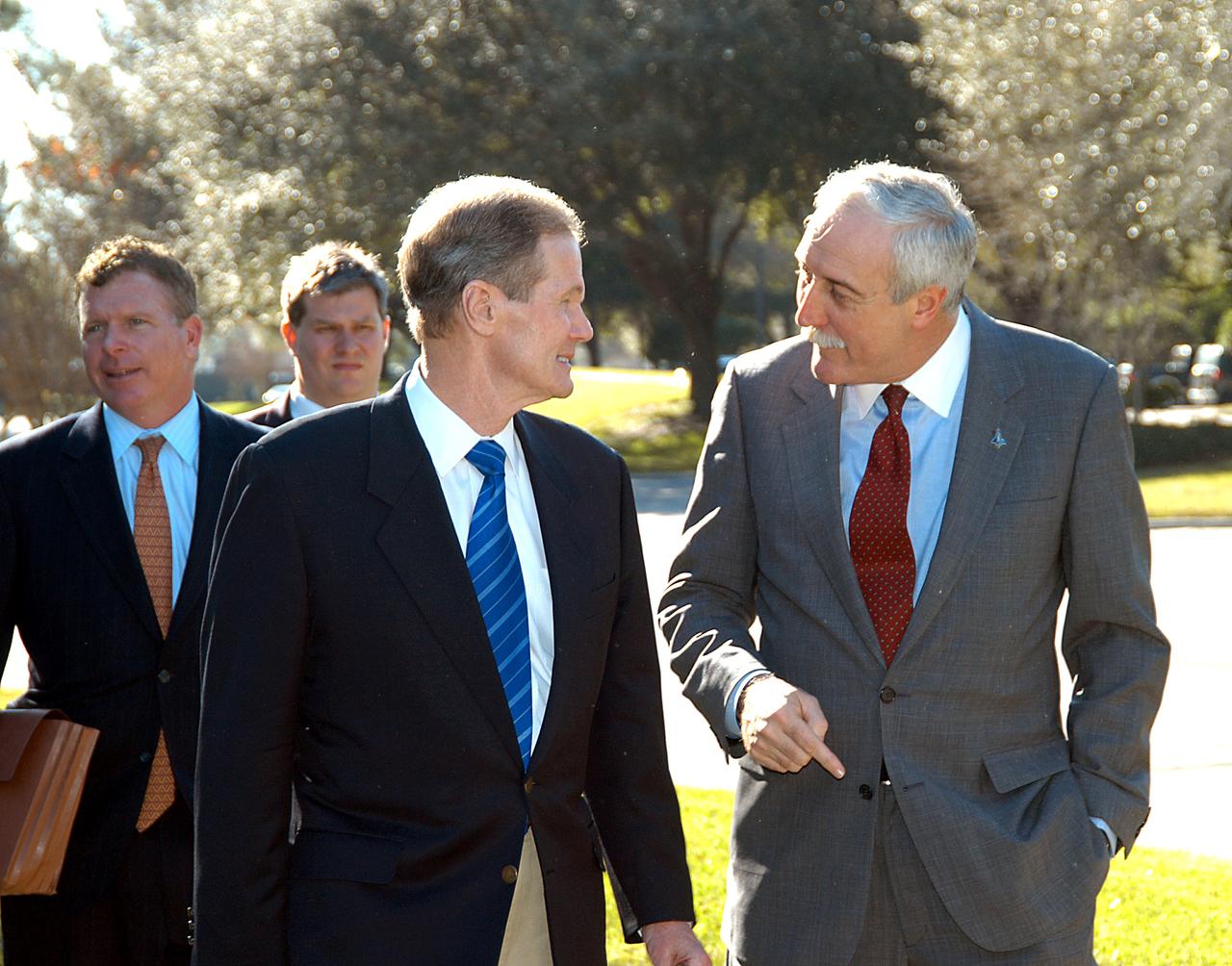 KENNEDY SPACE CENTER, FLA. - U.S. Senator Bill Nelson (center) and NASA Administrator Sean O’Keefe are deep in conversation as they leave the Central Florida Research Park, near Orlando.  Behind Nelson at left is Congressman Tom Feeney.  The research park is being proposed as the location for NASA’s new Shared Services Center. Six sites around the U.S. are under consideration for location of the Center, which would centralize NASA’s payroll, accounting, human resources, facilities and procurement offices that are now handled at each field center.  The consolidation is part of the One NASA focus.  Others attending the presentation included U.S. Representative Ric Keller, Congressman Dave Weldon, Center Director Jim Kennedy and Pamella J. Dana, Ph.D., director, Office of Tourism, Trade, and Economic Development in Florida.