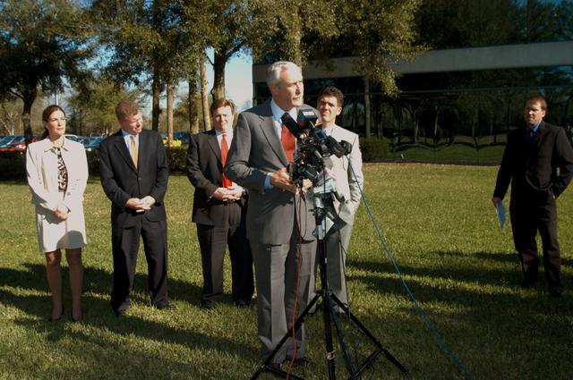NASA image: KENNEDY SPACE CENTER, FLA. - NASA Administrator Sean O’Keefe talks to the media at the Central Florida Research Park, near Orlando.  He and government officials were at the park for a presentation about the assets of the research park as the site of NASA’s new Shared Services Center. Behind O’Keefe are (left to right) Pamella J. Dana, Ph.D., director, Office of Tourism, Trade, and Economic Development in Florida; Florida Congressman Tom Feeney; U.S. Representative Ric Keller; and Congressman Dave Weldon.  At right is Mike Rein, division chief of KSC External Affairs.  Six sites around the U.S. are under consideration for location of the Center, which would centralize NASA’s payroll, accounting, human resources, facilities and procurement offices that are now handled at each field center.  The consolidation is part of the One NASA focus.  Others attending the presentation included  U.S. Senator Bill Nelson and Center Director Jim Kennedy.