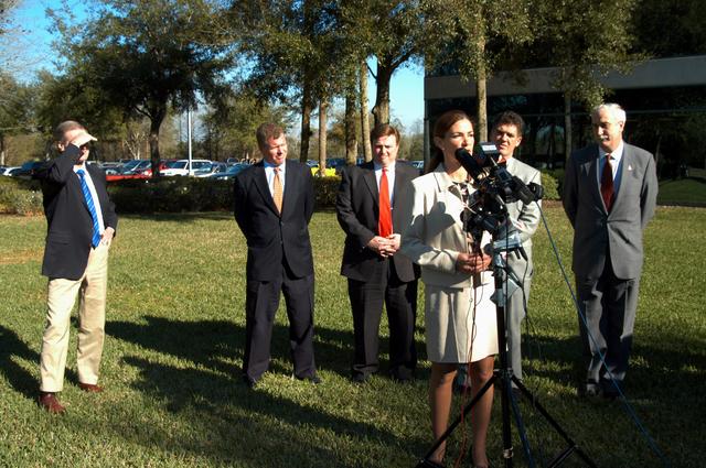 NASA image: KENNEDY SPACE CENTER, FLA. - Pamella J. Dana, Ph.D., director, Office of Tourism, Trade, and Economic Development in Florida, talks to the media at the Central Florida Research Park, near Orlando.  She gave a presentation to NASA Administrator Sean O’Keefe (far right) about the assets of the research park as the site of NASA’s new Shared Services Center.  Behind Dana are (left to right) U.S. Senator Bill Nelson, Florida Congressman Tom Feeney; U.S. Representative Ric Keller; and Congressman Dave Weldon.  Six sites around the U.S. are under consideration for location of the Center, which would centralize NASA’s payroll, accounting, human resources, facilities and procurement offices that are now handled at each field center.  The consolidation is part of the One NASA focus.  Center Director Jim Kennedy also attended the presentation.