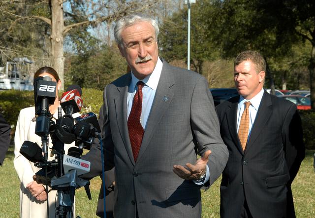 NASA image: KENNEDY SPACE CENTER, FLA. - NASA Administrator Sean O’Keefe talks to the media at the Central Florida Research Park, near Orlando.  He and government officials were at the park for a presentation about the assets of the research park as the site of NASA’s new Shared Services Center. Behind O’Keefe are (left to right) Pamella J. Dana, Ph.D., director, Office of Tourism, Trade, and Economic Development in Florida; and Florida Congressman Tom Feeney. Six sites around the U.S. are under consideration for location of the Center, which would centralize NASA’s payroll, accounting, human resources, facilities and procurement offices that are now handled at each field center.  The consolidation is part of the One NASA focus.  Others attending the presentation included  U.S. U.S. Senator Bill Nelson, U.S. Representative Ric Keller, Congressman Dave Weldon and Center Director Jim Kennedy.