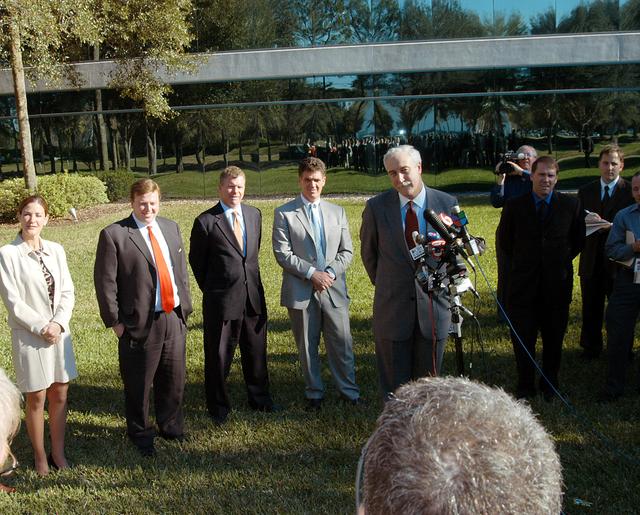 NASA image: KENNEDY SPACE CENTER, FLA. - NASA Administrator Sean O’Keefe talks to the media at the Central Florida Research Park, near Orlando.  He and government officials were at the park for a presentation about the assets of the research park as the site of NASA’s new Shared Services Center. Behind O’Keefe are (left to right) Pamella J. Dana, Ph.D., director, Office of Tourism, Trade, and Economic Development in Florida; U.S. Representative Ric Keller; Florida Congressman Tom Feeney; and Congressman Dave Weldon. At right is Mike Rein, division chief of KSC External Affairs.  Six sites around the U.S. are under consideration for location of the Center, which would centralize NASA’s payroll, accounting, human resources, facilities and procurement offices that are now handled at each field center.  The consolidation is part of the One NASA focus.  Others attending the presentation included  U.S. Senator Bill Nelson and Center Director Jim Kennedy.