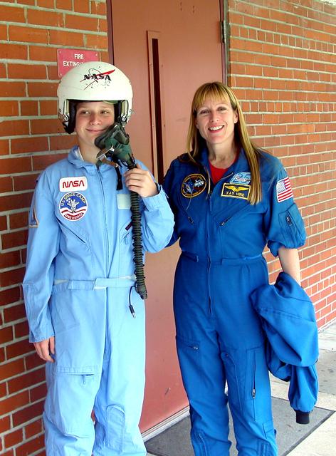 NASA image: KENNEDY SPACE CENTER, FLA. - Astronaut Kay Hire poses with 8th grader Kristy Wiggins at Garland V. Stewart Magnet Middle School, a NASA Explorer School (NES) in Tampa, Fla.  Hire joined Center Director Jim Kennedy at the school in sharing the agency’s new vision for space exploration with the next generation of explorers. Kennedy is talking with students about our destiny as explorers, NASA’s stepping stone approach to exploring Earth, the Moon, Mars and beyond, how space impacts our lives, and how people and machines rely on each other in space.