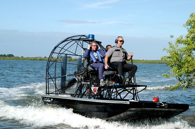 NASA image: KENNEDY SPACE CENTER, FLA. - Congressman Tom Feeney (left) and Deputy Director Woodrow Whitlow Jr. take an air boat ride around Kennedy Space Center.  During January and February, Congressman Feeney traveled the entire coastline of Florida’s 24th District, and concluded his walks March 1 in Brevard County.  On his walks, he met with constituents and community leaders to discuss legislative issues that will be addressed by the 108th Congress. Feeney ended his beach walk at the KSC Visitor Complex main entrance.