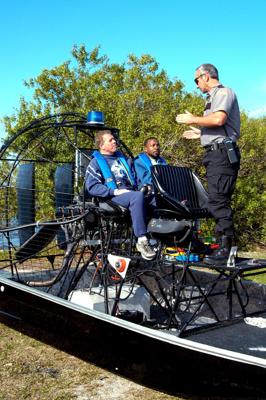 KENNEDY SPACE CENTER, FLA. - Before going on an air boat ride around Kennedy Space Center, Congressman Tom Feeney and Deputy Director Woodrow Whitlow Jr. are briefed about the trip. During January and February, Congressman Feeney traveled the entire coastline of Florida’s 24th District, and concluded his walks March 1 in Brevard County.  On his walks, he met with constituents and community leaders to discuss legislative issues that will be addressed by the 108th Congress.  Feeney ended his beach walk at the KSC Visitor Complex main entrance.