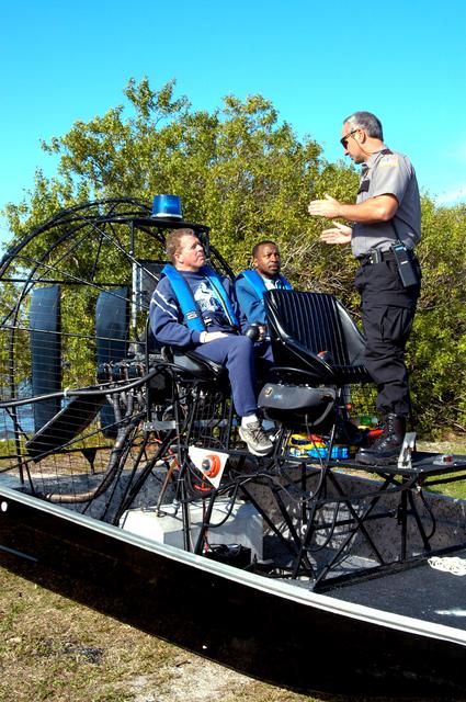 NASA image: KENNEDY SPACE CENTER, FLA. - Before going on an air boat ride around Kennedy Space Center, Congressman Tom Feeney and Deputy Director Woodrow Whitlow Jr. are briefed about the trip. During January and February, Congressman Feeney traveled the entire coastline of Florida’s 24th District, and concluded his walks March 1 in Brevard County.  On his walks, he met with constituents and community leaders to discuss legislative issues that will be addressed by the 108th Congress.  Feeney ended his beach walk at the KSC Visitor Complex main entrance.
