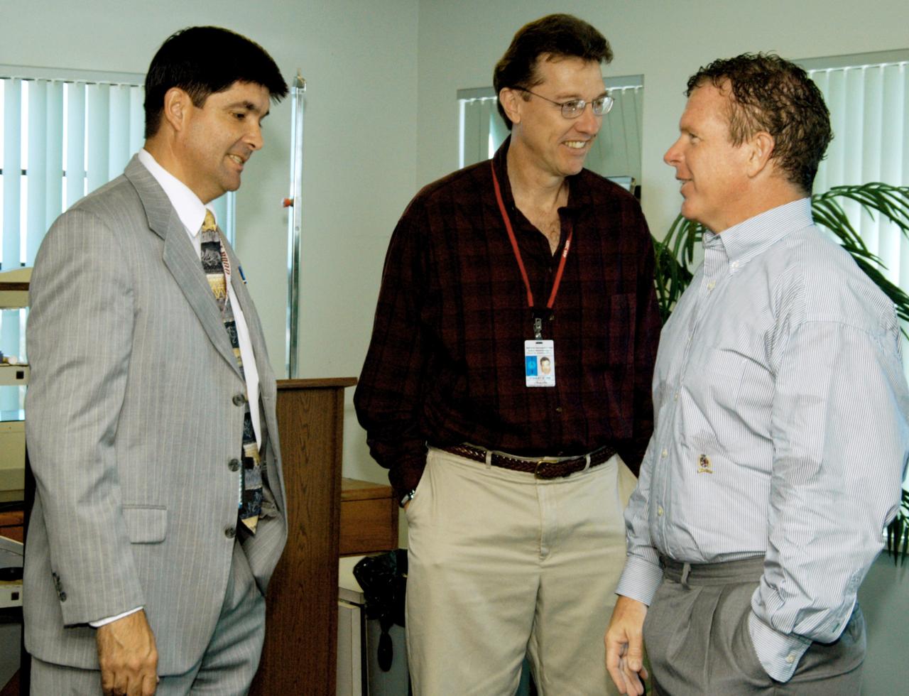 KENNEDY SPACE CENTER, FLA. - At the Beach House, Congressman Tom Feeney (right) talks with Glenn Vera (left), with Florida Spaceport Authority, and Stan Starr (center), with Dynamac Corp.  During January and February, Congressman Feeney traveled the entire coastline of Florida’s 24th District, and concluded his walks March 1 in Brevard County.  On his walks, he met with constituents and community leaders to discuss legislative issues that will be addressed by the 108th Congress.