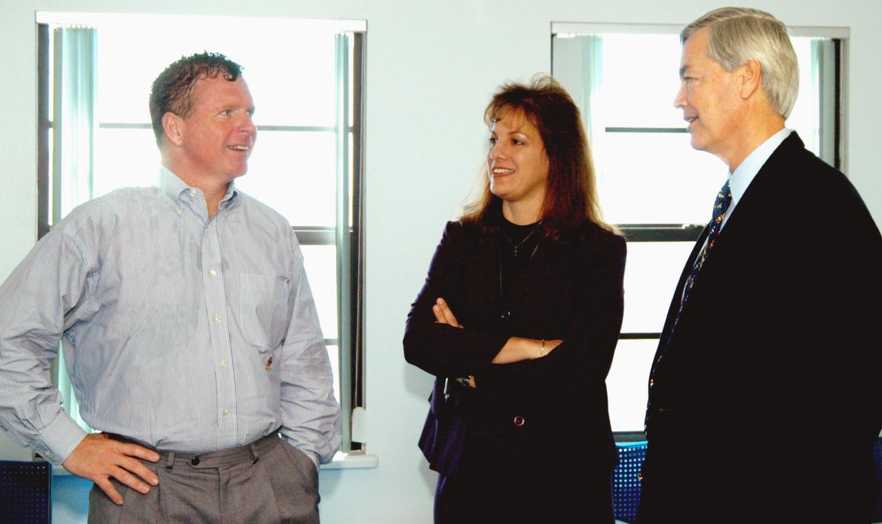 KENNEDY SPACE CENTER, FLA. - At the Beach House, Congressman Tom Feeney (left) talks with William Sample (right), president of Space Gateway Support.  In the center is the Congressman’s wife, Ellen.   During January and February, Congressman Feeney traveled the entire coastline of Florida’s 24th District, and concluded his walks March 1 in Brevard County.  On his walks, he met with constituents and community leaders to discuss legislative issues that will be addressed by the 108th Congress.