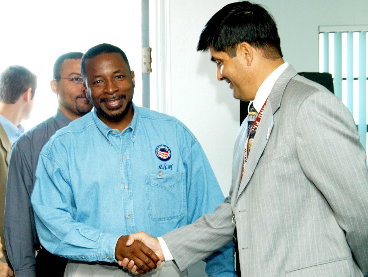 KENNEDY SPACE CENTER, FLA. - At the Beach House, Deputy Director Woodrow Whitlow Jr. greets Glenn Vera, with Florida Spaceport Authority.  The two joined Congressman Tom Feeney who concluded his walks along the entire coastline of Florida’s 24th District March 1 on the beach at Kennedy Space Center. During his walks, he met with constituents and community leaders to discuss legislative issues that will be addressed by the 108th Congress.