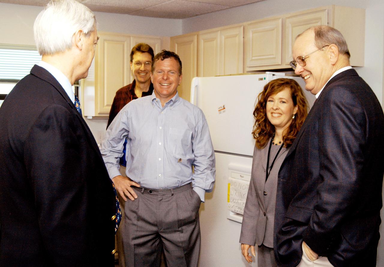 KENNEDY SPACE CENTER, FLA. - At the Beach House, Congressman Tom Feeney (center) relaxes after his walk on Brevard County’s beach north of the launch pads. With him are William Sample (left), president of Space Gateway Support at KSC; Stan Starr, with Dynamac Corp.; Lisa Malone, director of External Affairs at KSC; and Jim Hattaway, associate director of KSC. During January and February, Congressman Feeney traveled the entire coastline of Florida’s 24th District, and concluded his walks March 1 in Brevard County. On his walks, he met with constituents and community leaders to discuss legislative issues that will be addressed by the 108th Congress.