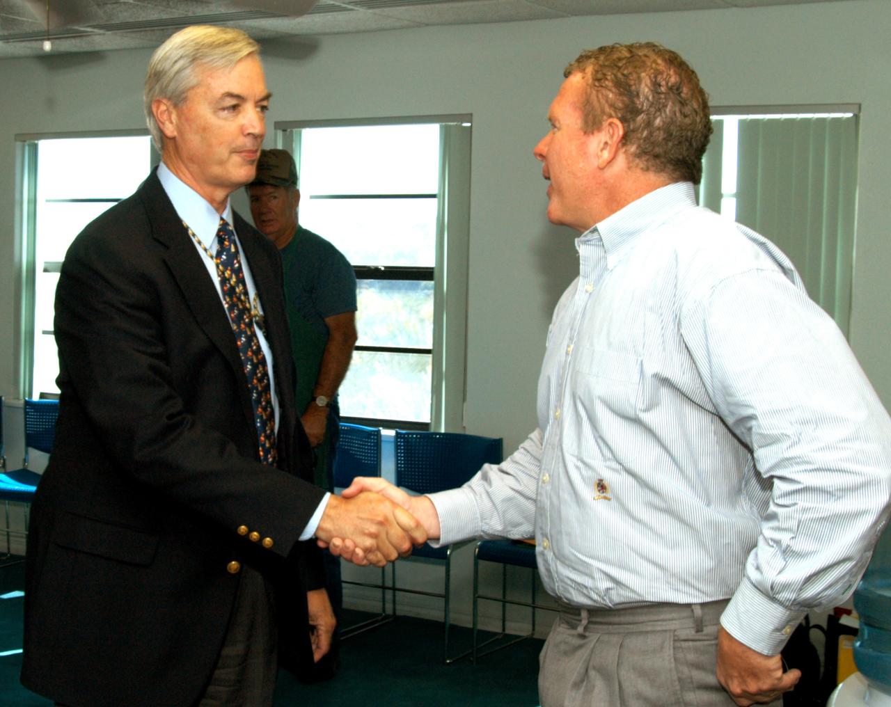 KENNEDY SPACE CENTER, FLA. - At the Beach House, Congressman Tom Feeney (right) greets William Sample, president of Space Gateway Support.  During January and February, Congressman Feeney traveled the entire coastline of Florida’s 24th District, and concluded his walks March 1 in Brevard County.  On his walks, he met with constituents and community leaders to discuss legislative issues that will be addressed by the 108th Congress.