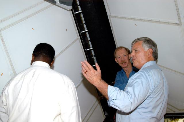 NASA image: KENNEDY SPACE CENTER, FLA. - On a tour of the Orbiter Processing Facility, Center Director Jim Kennedy (right) and Deputy Director Woodrow Whitlow Jr. (center) look at the rudder speed brake panels on the orbiter Endeavour.  In the background is Tom Roberts, who is with United Space Alliance.  Endeavour is in its Orbiter Major Modification period, which began in December 2003.