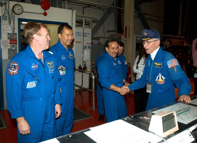 NASA image: KENNEDY SPACE CENTER, FLA. - -  In the Orbiter Processing Facility, STS-114 Mission Specialists Andrew Thomas, Soichi Noguchi and Charles Camarda greet astronaut John Young (far right), who flew on the first flight of Space Shuttle Columbia with Robert Crippen.  Behind Camarda is Pilot James Kelly.  Young is associate director, Technical, at Johnson Space Center.  Noguchi represents the Japanese Aerospace and Exploration Agency.  The STS-114 crew is spending time becoming familiar with Shuttle and mission equipment.  The mission is Logistics Flight 1, which is scheduled to deliver supplies and equipment plus the external stowage platform to the International Space Station.
