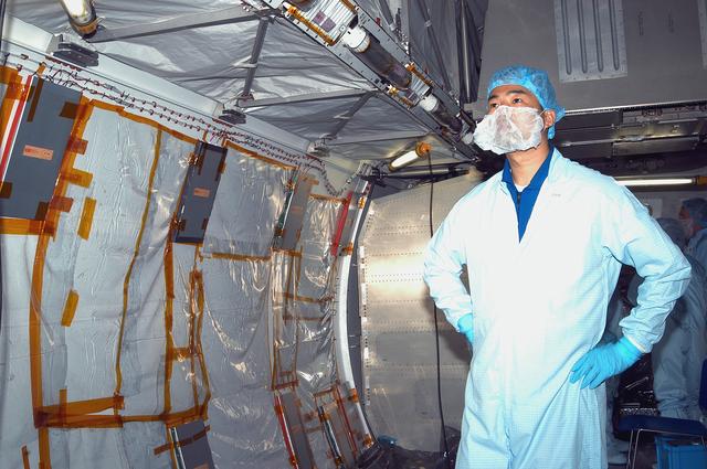 NASA image: KENNEDY SPACE CENTER, FLA. - STS-114 Mission Specialist Soichi Noguchi, who is with the Japanese Aerospace and Exploration Agency, looks at the inside of the Japanese Experiment Module (JEM) in the Space Station Processing Facility.  He and other crew members are at KSC becoming familiar with Shuttle and mission equipment. The mission is Logistics Flight 1, which is scheduled to deliver supplies and equipment plus the external stowage platform to the International Space Station.