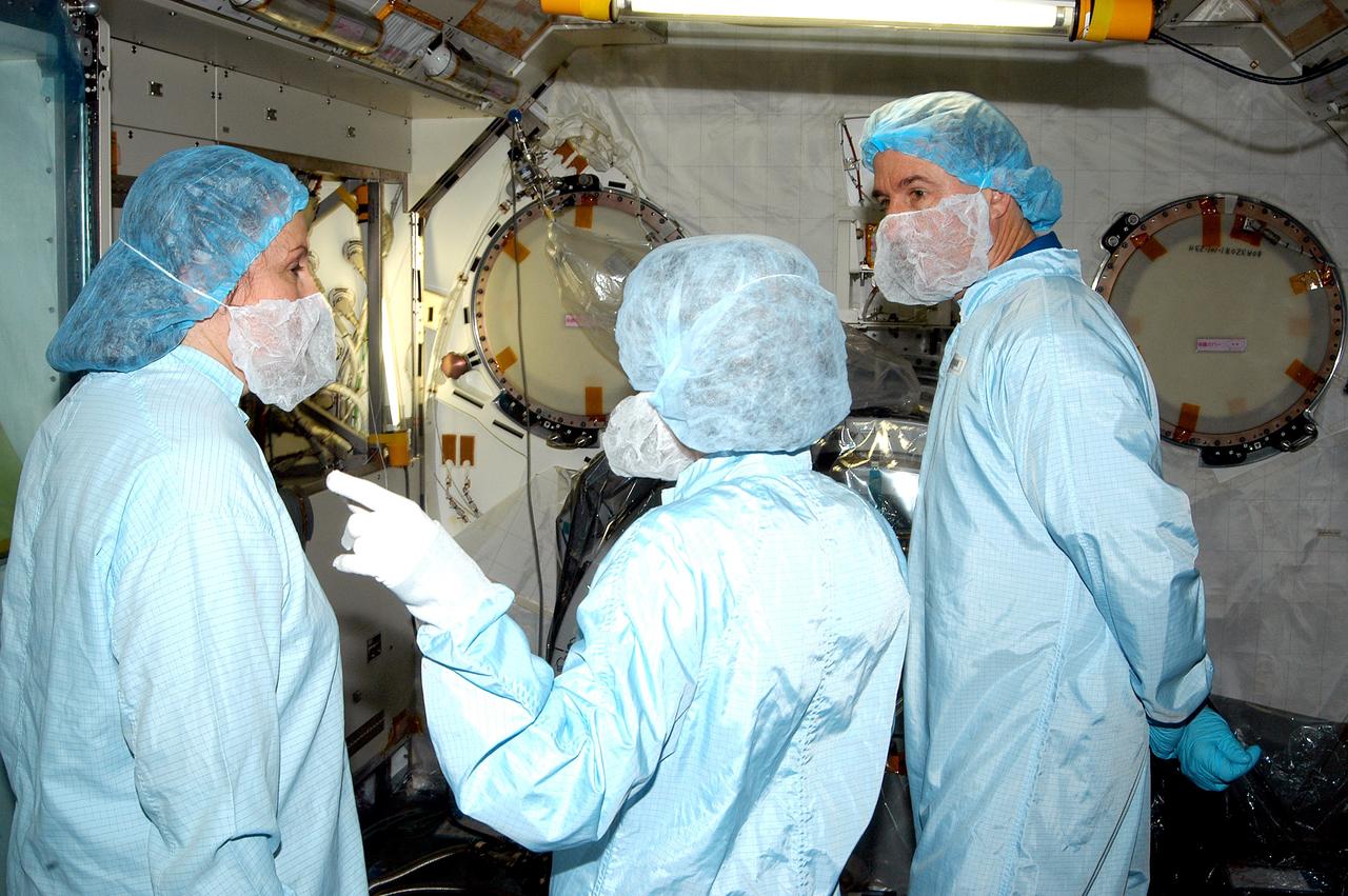 KENNEDY SPACE CENTER, FLA. - In the Space Station Processing Facility, STS-114 Mission Specialist Stephen Robinson (right) learns about the Japanese Experiment Module (JEM) from Louise Kleba (left), with United Space Alliance at KSC, and Jennifer Goldsmith (center), with USA at Johnson Space Center. Crew members are at KSC becoming familiar with Shuttle and mission equipment. The mission is Logistics Flight 1, which is scheduled to deliver supplies and equipment plus the external stowage platform to the International Space Station.