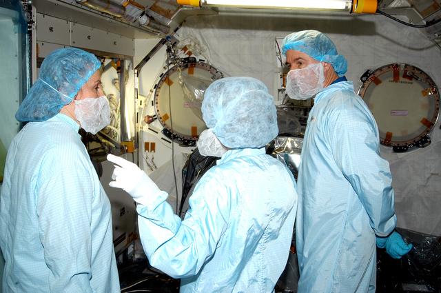 NASA image: KENNEDY SPACE CENTER, FLA. - In the Space Station Processing Facility, STS-114 Mission Specialist Stephen Robinson (right) learns about the Japanese Experiment Module (JEM) from Louise Kleba (left), with United Space Alliance at KSC, and Jennifer Goldsmith (center), with USA at Johnson Space Center. Crew members are at KSC becoming familiar with Shuttle and mission equipment. The mission is Logistics Flight 1, which is scheduled to deliver supplies and equipment plus the external stowage platform to the International Space Station.