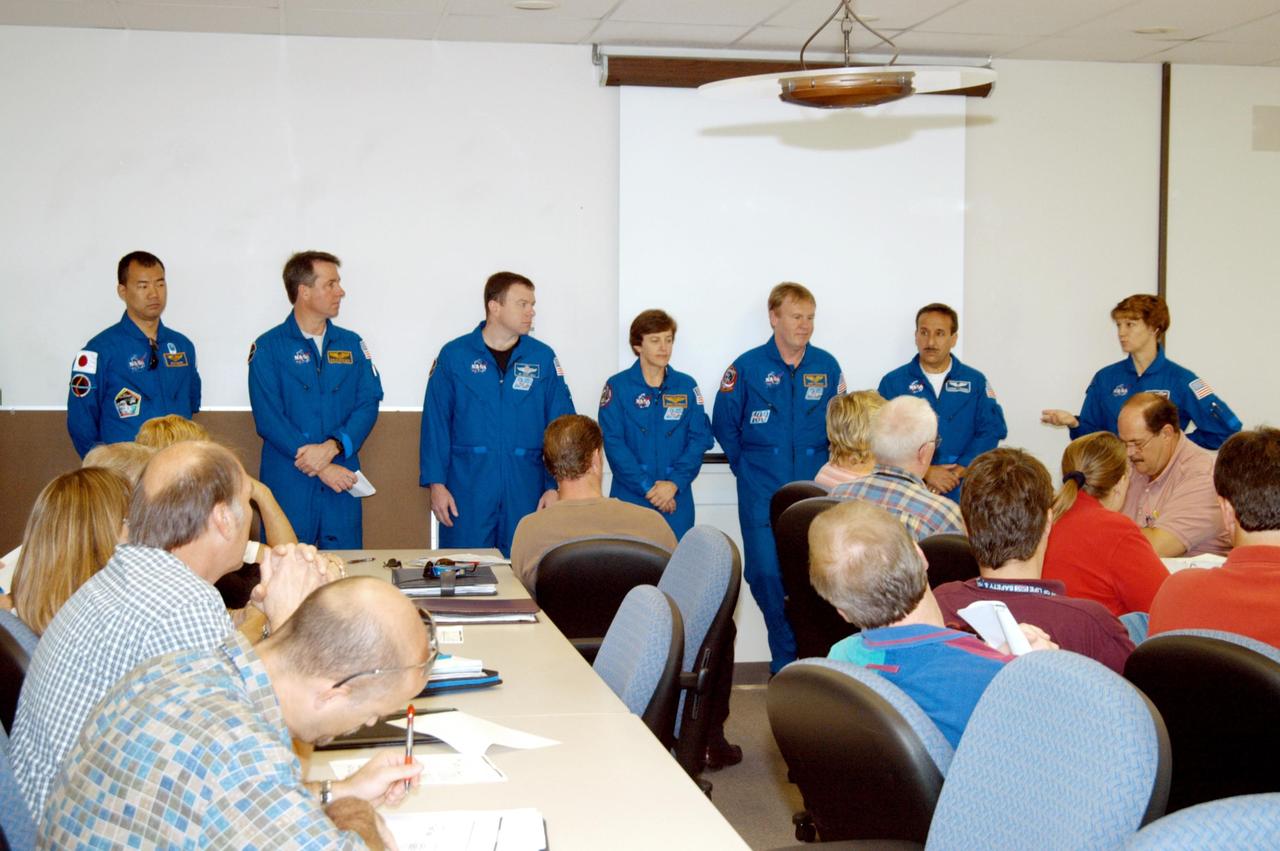 KENNEDY SPACE CENTER, FLA. -  The STS-114 crew talks to the Discovery processing team in the Orbiter Processing Facility. The crew members, from left, are Mission Specialists Soichi Noguchi and Stephen Robinson; Pilot James Kelly; Mission Specialists Wendy Lawrence, Andrew Thomas and Charles Camarda; and Commander Eileen Collins.  Noguchi represents the Japanese Aerospace and Exploration Agency.  The crew is at KSC for familiarization with Shuttle and mission equipment. The STS-114 mission is Logistics Flight 1, which is scheduled to deliver supplies and equipment, plus the external stowage platform, to the International Space Station.