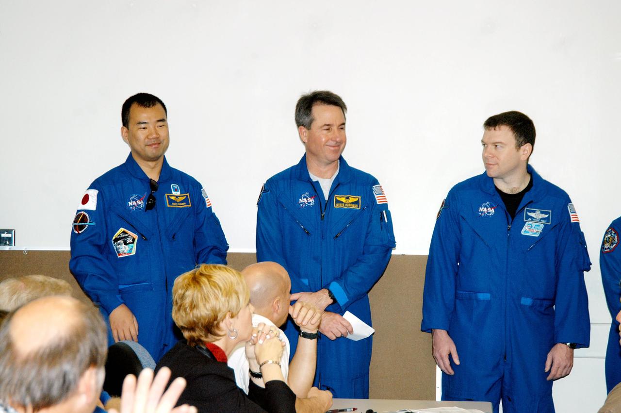 KENNEDY SPACE CENTER, FLA. -  The STS-114 crew talks to the Discovery processing team in the Orbiter Processing Facility. The crew members, from left, are Mission Specialists Soichi Noguchi and Stephen Robinson and Pilot James Kelly.  Also present but not pictured are Mission Specialists Wendy Lawrence, Andrew Thomas and Charles Camarda; and Commander Eileen Collins. Noguchi represents the Japanese Aerospace and Exploration Agency.  The crew is at KSC for familiarization with Shuttle and mission equipment. The STS-114 mission is Logistics Flight 1, which is scheduled to deliver supplies and equipment, plus the external stowage platform, to the International Space Station.