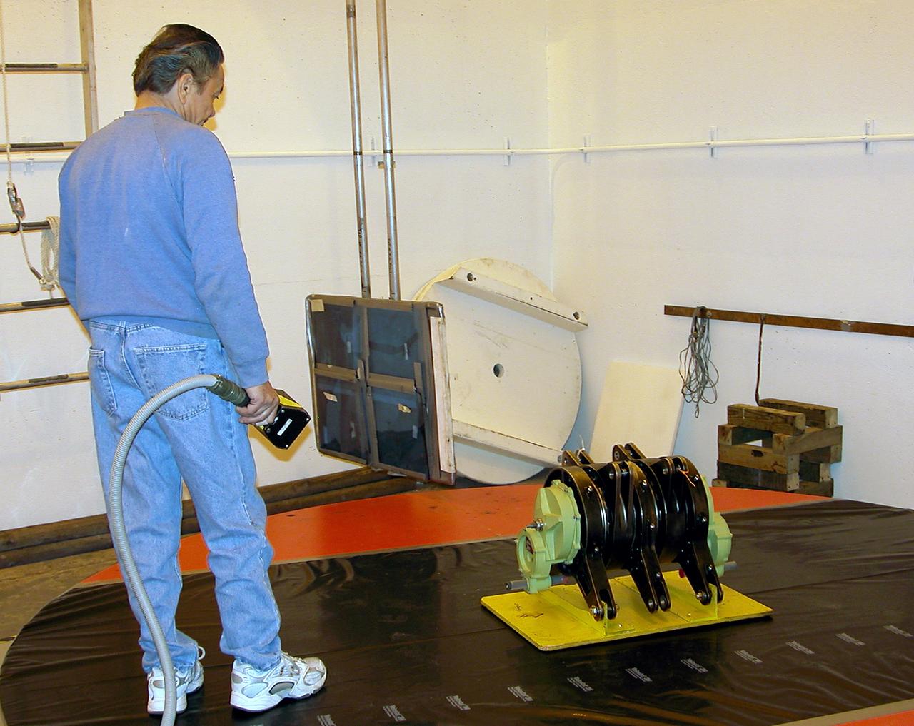 KENNEDY SPACE CENTER, FLA. -  A rudder speed brake actuator sits on an air-bearing pallet to undergo X-raying.  Four actuators to be installed on the orbiter Discovery are being X-rayed at the Radiographic High-Energy X-ray Facility to determine if the gears were installed correctly. Discovery has been assigned to the first Return to Flight mission, STS-114, a logistics flight to the International Space Station.