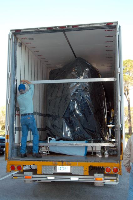 NASA image: KENNEDY SPACE CENTER, FLA. -  Doors are open on the air-conditioned transportation van that carried NASA’s MESSENGER spacecraft from NASA’s Goddard Space Flight Center in Greenbelt, Md., to the Astrotech Space Operations processing facilities near KSC.  After offloading, MESSENGER - short for MErcury Surface, Space ENvironment, GEochemistry and Ranging - will be taken into a high bay clean room and employees of the Johns Hopkins University Applied Physics Laboratory, builders of the spacecraft, will perform an initial state-of-health check.  Then processing for launch can begin, including checkout of the power systems, communications systems and control systems.  The thermal blankets will also be attached for flight.  MESSENGER will be launched May 11 on a six-year mission aboard a Boeing Delta II rocket.  Liftoff is targeted for 2:26 a.m. EDT on Tuesday, May 11.