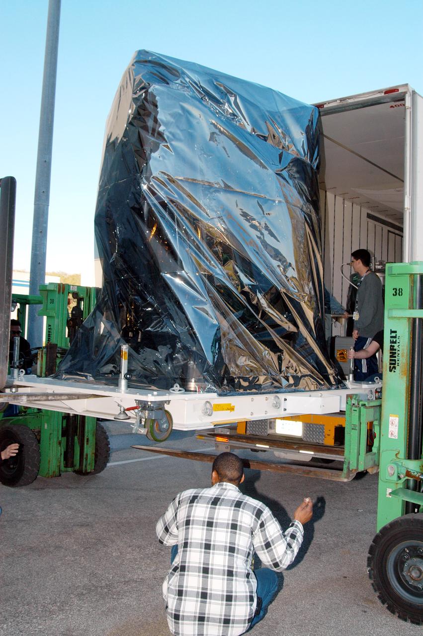 KENNEDY SPACE CENTER, FLA. -  At the Astrotech Space Operations processing facilities near KSC, a lift helps offload NASA’s MESSENGER spacecraft shipped from NASA’s Goddard Space Flight Center in Greenbelt, Md.  MESSENGER - short for MErcury Surface, Space ENvironment, GEochemistry and Ranging - will be taken into a high bay clean room and employees of the Johns Hopkins University Applied Physics Laboratory, builders of the spacecraft, will perform an initial state-of-health check.  Then processing for launch can begin, including checkout of the power systems, communications systems and control systems.  The thermal blankets will also be attached for flight.  MESSENGER will be launched May 11 on a six-year mission aboard a Boeing Delta II rocket.  Liftoff is targeted for 2:26 a.m. EDT on Tuesday, May 11.