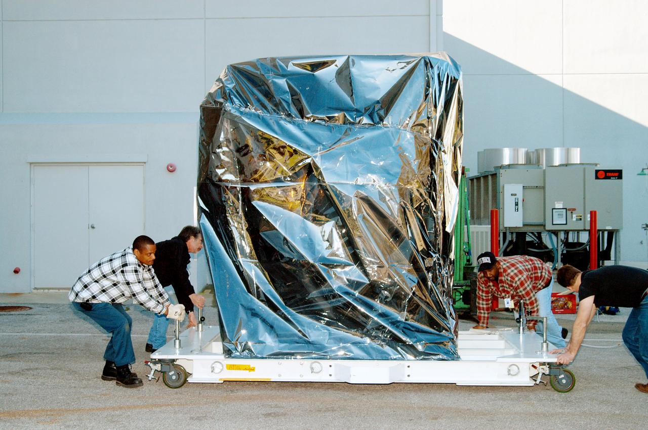 KENNEDY SPACE CENTER, FLA. -  At the Astrotech Space Operations processing facilities near KSC, workers check the moveable pallet holding NASA’s MESSENGER spacecraft.  MESSENGER - short for MErcury Surface, Space ENvironment, GEochemistry and Ranging - will be taken into a high bay clean room and employees of the Johns Hopkins University Applied Physics Laboratory, builders of the spacecraft, will perform an initial state-of-health check.  Then processing for launch can begin, including checkout of the power systems, communications systems and control systems.  The thermal blankets will also be attached for flight.  MESSENGER will be launched May 11 on a six-year mission aboard a Boeing Delta II rocket.  Liftoff is targeted for 2:26 a.m. EDT on Tuesday, May 11.