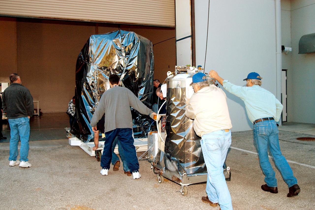 KENNEDY SPACE CENTER, FLA. -  At the Astrotech Space Operations processing facilities near KSC, workers begin moving NASA’s MESSENGER spacecraft into the building  MESSENGER - short for MErcury Surface, Space ENvironment, GEochemistry and Ranging - is being taken into a high bay clean room where employees of the Johns Hopkins University Applied Physics Laboratory, builders of the spacecraft, will perform an initial state-of-health check.  Then processing for launch can begin, including checkout of the power systems, communications systems and control systems.  The thermal blankets will also be attached for flight.  MESSENGER will be launched May 11 on a six-year mission aboard a Boeing Delta II rocket.  Liftoff is targeted for 2:26 a.m. EDT on Tuesday, May 11.