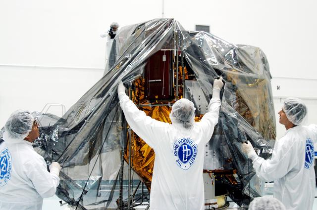 KENNEDY SPACE CENTER, FLA. -  In the high bay clean room at the Astrotech Space Operations processing facilities near KSC, workers remove the protective cover from NASA’s MESSENGER spacecraft.  Employees of the Johns Hopkins University Applied Physics Laboratory, builders of the spacecraft, will perform an initial state-of-health check.  Then processing for launch can begin, including checkout of the power systems, communications systems and control systems.  The thermal blankets will also be attached for flight.  MESSENGER - short for MErcury Surface, Space ENvironment, GEochemistry and Ranging - will be launched May 11 on a six-year mission aboard a Boeing Delta II rocket.  Liftoff is targeted for 2:26 a.m. EDT on Tuesday, May 11.