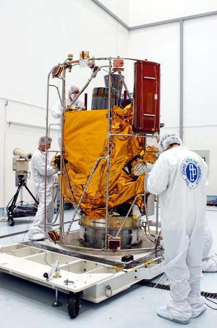 KENNEDY SPACE CENTER, FLA. -  In the high bay clean room at the Astrotech Space Operations processing facilities near KSC, NASA’s MESSENGER spacecraft is revealed.  Employees of the Johns Hopkins University Applied Physics Laboratory, builders of the spacecraft, will perform an initial state-of-health check.  Then processing for launch can begin, including checkout of the power systems, communications systems and control systems.  The thermal blankets will also be attached for flight.  MESSENGER - short for MErcury Surface, Space ENvironment, GEochemistry and Ranging - will be launched May 11 on a six-year mission aboard a Boeing Delta II rocket.  Liftoff is targeted for 2:26 a.m. EDT on Tuesday, May 11.