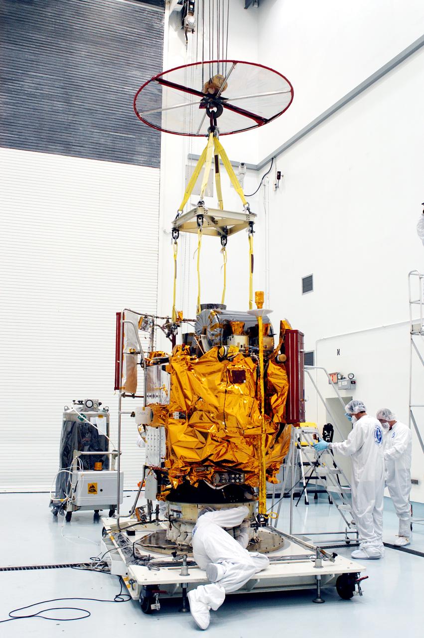 KENNEDY SPACE CENTER, FLA. -  In the high bay clean room at the Astrotech Space Operations processing facilities near KSC, workers attach an overhead crane to NASA’s MESSENGER spacecraft.  The spacecraft will be moved to a work stand where employees of the Johns Hopkins University Applied Physics Laboratory, builders of the spacecraft, will perform an initial state-of-health check.  Then processing for launch can begin, including checkout of the power systems, communications systems and control systems.  The thermal blankets will also be attached for flight.  MESSENGER - short for MErcury Surface, Space ENvironment, GEochemistry and Ranging - will be launched May 11 on a six-year mission aboard a Boeing Delta II rocket.  Liftoff is targeted for 2:26 a.m. EDT on Tuesday, May 11.