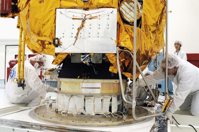 NASA image: KENNEDY SPACE CENTER, FLA. -  In the high bay clean room at the Astrotech Space Operations processing facilities near KSC, workers prepare NASA’s MESSENGER spacecraft for transfer to a work stand.  There employees of the Johns Hopkins University Applied Physics Laboratory, builders of the spacecraft, will perform an initial state-of-health check.  Then processing for launch can begin, including checkout of the power systems, communications systems and control systems.  The thermal blankets will also be attached for flight.  MESSENGER - short for MErcury Surface, Space ENvironment, GEochemistry and Ranging - will be launched May 11 on a six-year mission aboard a Boeing Delta II rocket.  Liftoff is targeted for 2:26 a.m. EDT on Tuesday, May 11.