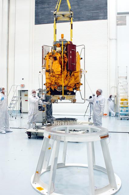 NASA image: KENNEDY SPACE CENTER, FLA. -  At the Astrotech Space Operations processing facilities, an overhead crane moves NASA’s MESSENGER spacecraft toward a work stand. There employees of the Johns Hopkins University Applied Physics Laboratory, builders of the spacecraft, will perform an initial state-of-health check.  Then processing for launch can begin, including checkout of the power systems, communications systems and control systems.  The thermal blankets will also be attached for flight.  MESSENGER - short for MErcury Surface, Space ENvironment, GEochemistry and Ranging - will be launched May 11 on a six-year mission aboard a Boeing Delta II rocket.  Liftoff is targeted for 2:26 a.m. EDT on Tuesday, May 11.