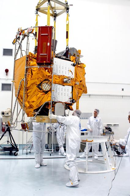 NASA image: KENNEDY SPACE CENTER, FLA. -  At the Astrotech Space Operations processing facilities, an overhead crane lowers NASA’s MESSENGER spacecraft onto a work stand. There employees of the Johns Hopkins University Applied Physics Laboratory, builders of the spacecraft, will perform an initial state-of-health check.  Then processing for launch can begin, including checkout of the power systems, communications systems and control systems.  The thermal blankets will also be attached for flight.  MESSENGER - short for MErcury Surface, Space ENvironment, GEochemistry and Ranging - will be launched May 11 on a six-year mission aboard a Boeing Delta II rocket.  Liftoff is targeted for 2:26 a.m. EDT on Tuesday, May 11.