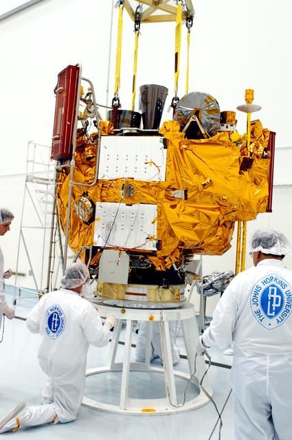 NASA image: KENNEDY SPACE CENTER, FLA. -  At the Astrotech Space Operations processing facilities, workers check the placement of NASA’s MESSENGER spacecraft on a work stand. There employees of the Johns Hopkins University Applied Physics Laboratory, builders of the spacecraft, will perform an initial state-of-health check.  Then processing for launch can begin, including checkout of the power systems, communications systems and control systems.  The thermal blankets will also be attached for flight.  MESSENGER - short for MErcury Surface, Space ENvironment, GEochemistry and Ranging - will be launched May 11 on a six-year mission aboard a Boeing Delta II rocket.  Liftoff is targeted for 2:26 a.m. EDT on Tuesday, May 11.
