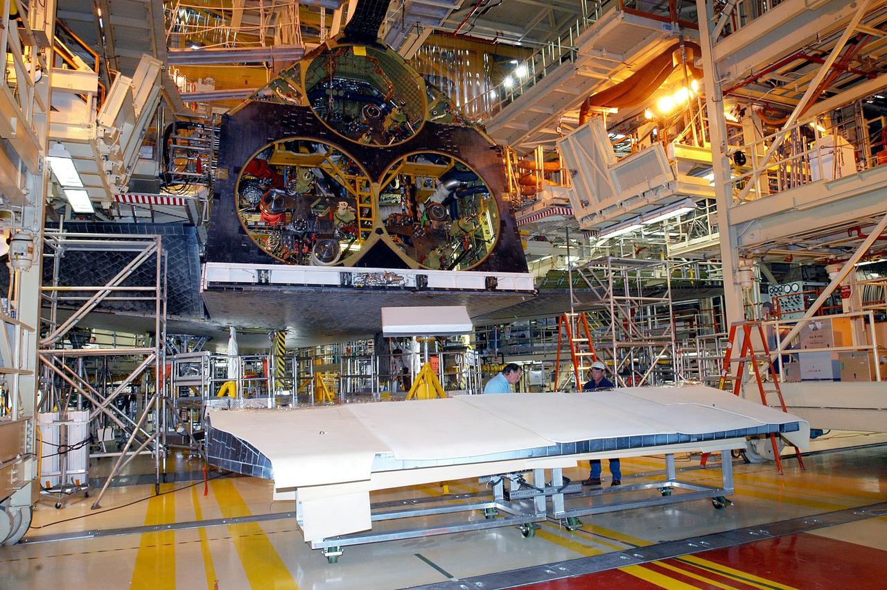 KENNEDY SPACE CENTER, FLA. -  In the Orbiter Processing Facility, the body flap for the orbiter Discovery is prepared for installation. The body flap is an aluminum structure consisting of ribs, spars, skin panels and a trailing edge assembly. It thermally shields the three main engines during entry and provides pitch control trim during landing approach.  Discovery is being processed for launch on the first Return to Flight mission, STS-114.