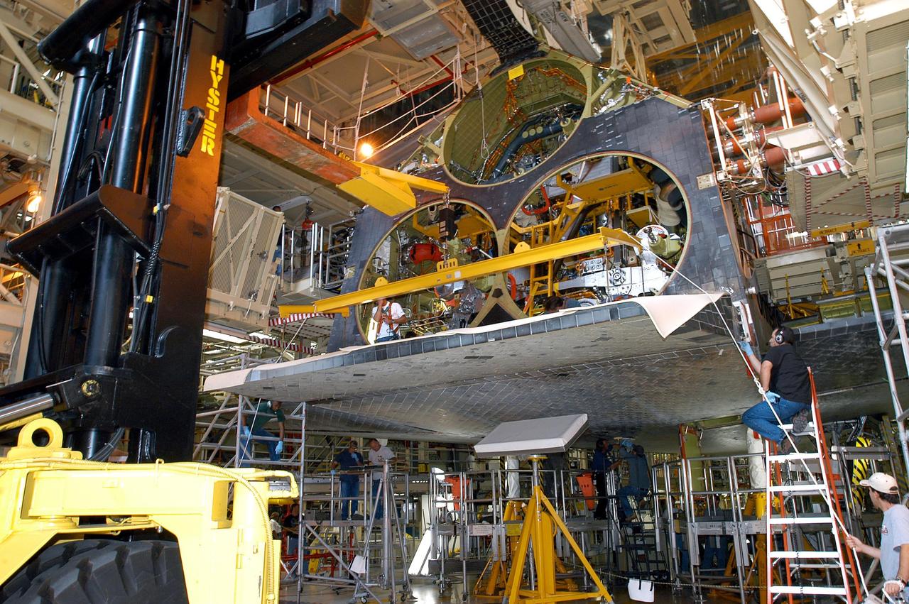 KENNEDY SPACE CENTER, FLA. -  The body flap is installed on the orbiter Discovery. The body flap is an aluminum structure consisting of ribs, spars, skin panels and a trailing edge assembly. It thermally shields the three main engines during entry and provides pitch control trim during landing approach. Discovery is being processed for launch on the first Return to Flight mission, STS-114.
