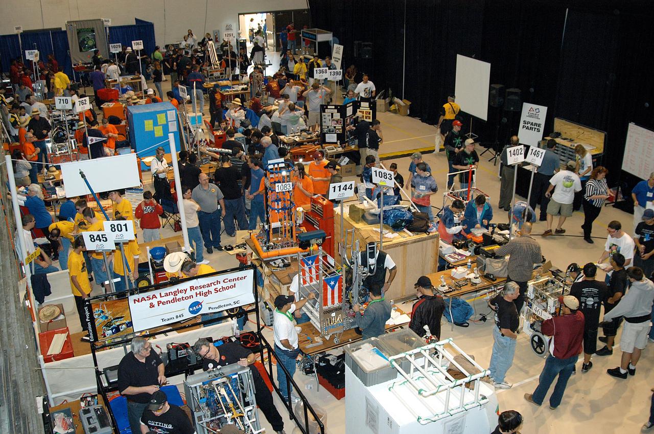 KENNEDY SPACE CENTER, FLA. -  Many of the 41 teams competing in the 2004 Florida Regional FIRST competition at the University of Central Florida are seen here preparing their robots for a match.  KSC sponsored the “Pink” team of Cocoa Beach and Rockledge High School students.  Among observers at the annual event were Center Director Jim Kennedy and Florida Gov. Jeb Bush, who spoke at the event luncheon.  FIRST is a nonprofit organization, For Inspiration and Recognition of Science and Technology, that sponsors the event pitting gladiator robots against each other in an athletic-style competition. The FIRST robotics competition is designed to provide students with a hands-on, inside look at engineering and other professional careers, pairing high school students with engineer mentors and corporations.