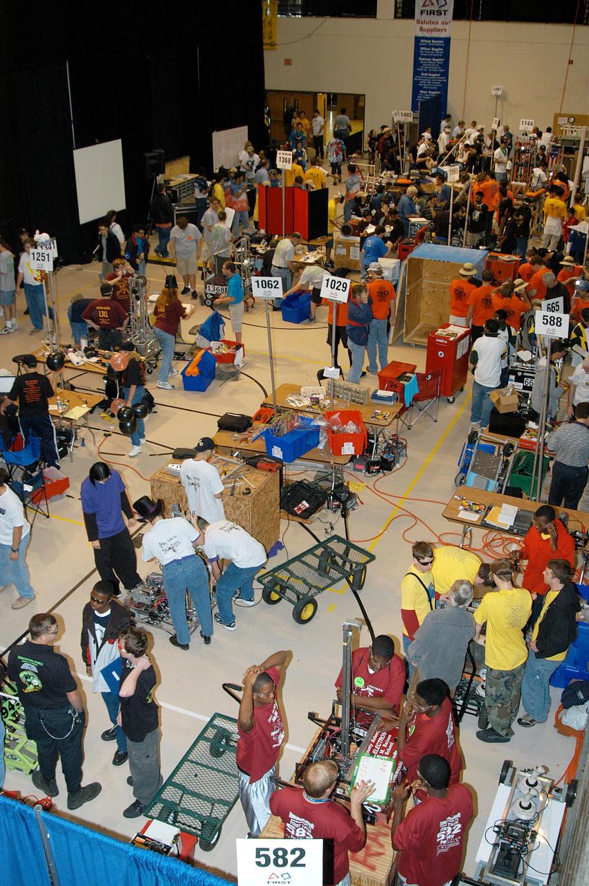 KENNEDY SPACE CENTER, FLA. -  Many of the 41 teams competing in the 2004 Florida Regional FIRST competition at the University of Central Florida are seen here preparing their robots for a match.  KSC sponsored the “Pink” team of Cocoa Beach and Rockledge High School students.  Among observers at the annual event were Center Director Jim Kennedy and Florida Gov. Jeb Bush, who spoke at the event luncheon.  FIRST is a nonprofit organization, For Inspiration and Recognition of Science and Technology, that sponsors the event pitting gladiator robots against each other in an athletic-style competition. The FIRST robotics competition is designed to provide students with a hands-on, inside look at engineering and other professional careers, pairing high school students with engineer mentors and corporations.
