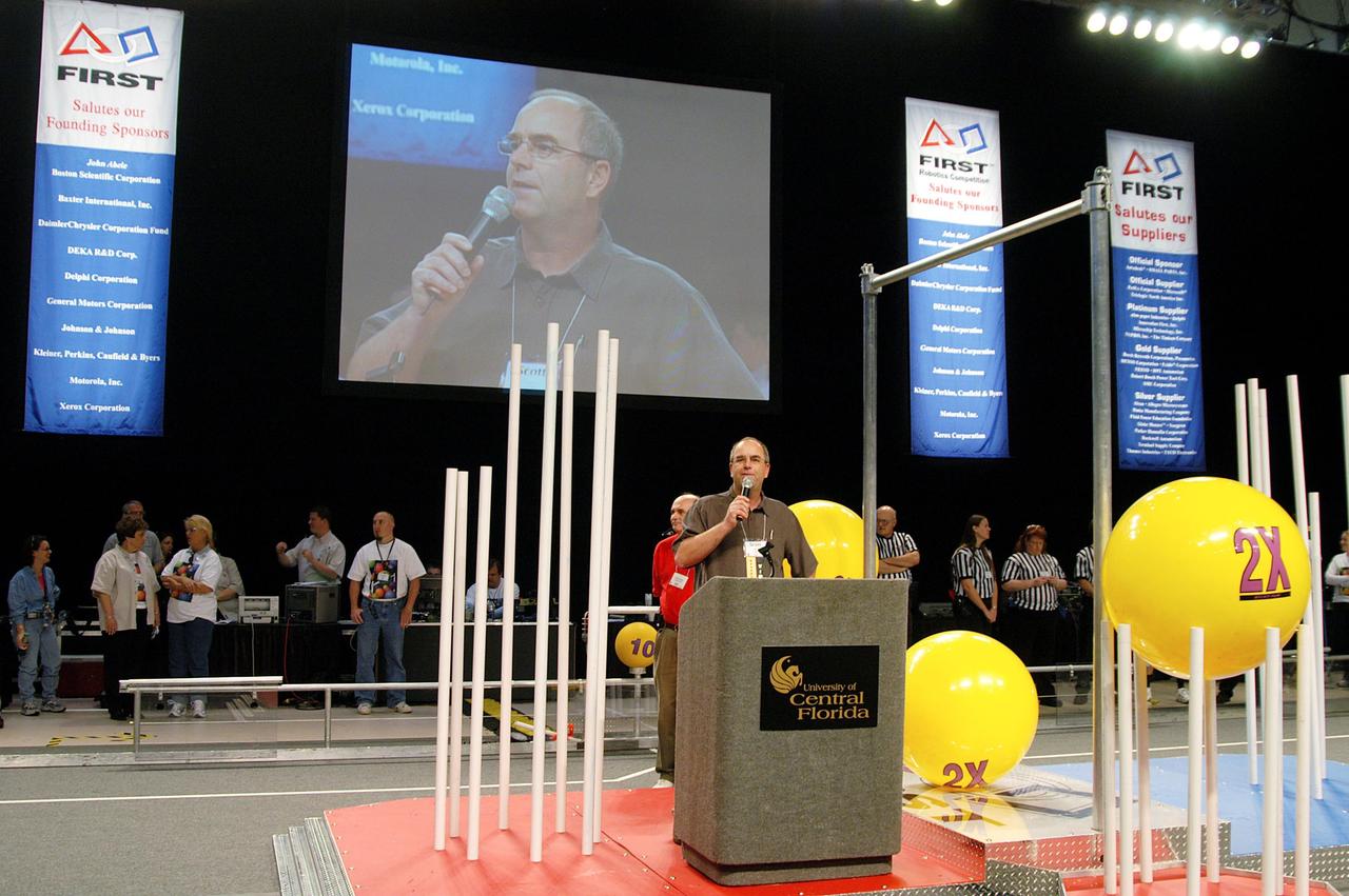 KENNEDY SPACE CENTER, FLA. -  Scott Kerr, director of Spaceport Services at KSC, speaks to students and attendees at the 2004 Florida Regional FIRST competition, held at the University of Central Florida Arena.  KSC sponsored the “Pink” team of Cocoa Beach and Rockledge High School students.  Among observers at the annual event were Center Director Jim Kennedy and Florida Gov. Jeb Bush, who spoke at the event luncheon.  FIRST is a nonprofit organization, For Inspiration and Recognition of Science and Technology, that sponsors the event pitting gladiator robots against each other in an athletic-style competition. The FIRST robotics competition is designed to provide students with a hands-on, inside look at engineering and other professional careers, pairing high school students with engineer mentors and corporations.