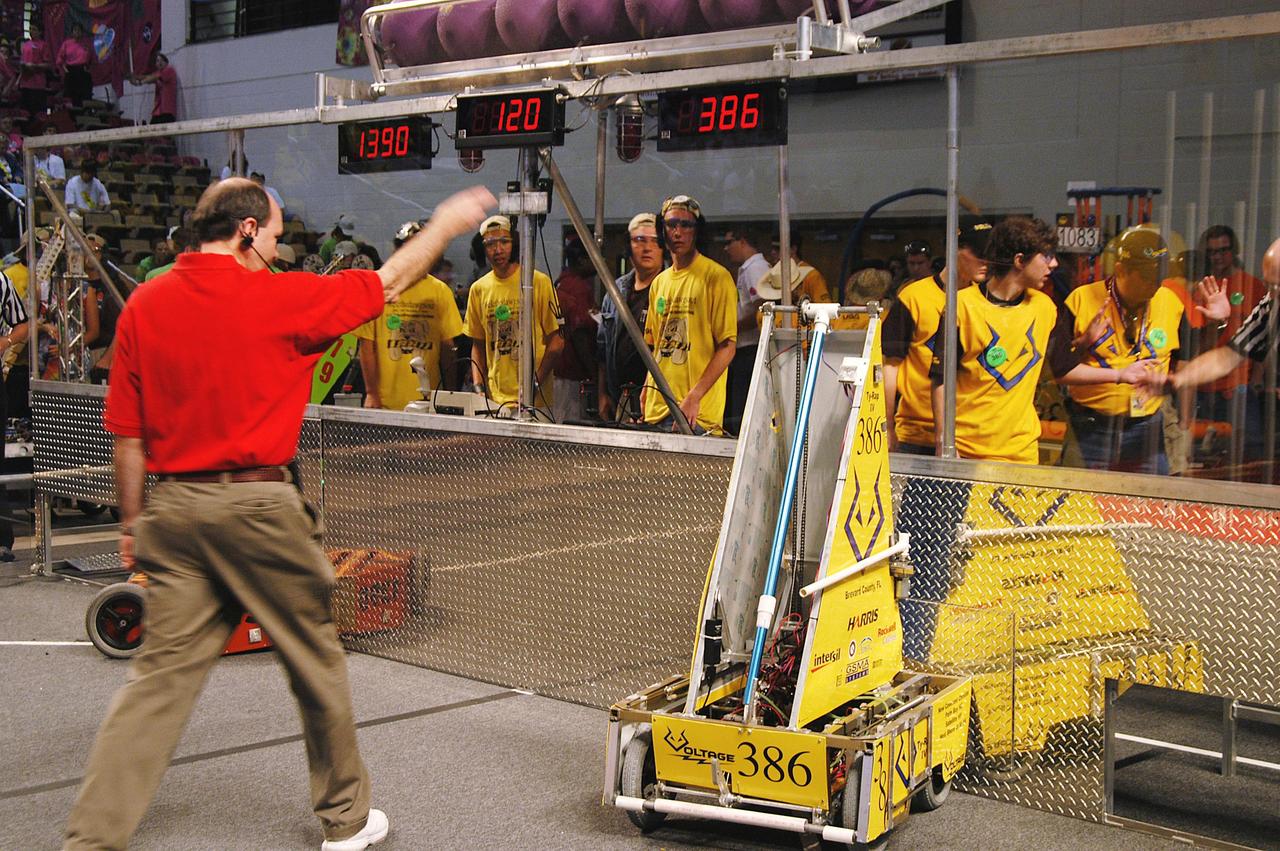 KENNEDY SPACE CENTER, FLA. -  In the University of Central Florida Arena, a local Central Florida team takes its turn during the 2004 Florida Regional FIRST competition. The event hosted 41 teams from Canada, Brazil, Great Britain and the United States.  Among observers at the annual event were Center Director Jim Kennedy and Florida Gov. Jeb Bush, who spoke at the event luncheon.  FIRST is a nonprofit organization, For Inspiration and Recognition of Science and Technology, that sponsors the event pitting gladiator robots against each other in an athletic-style competition. The FIRST robotics competition is designed to provide students with a hands-on, inside look at engineering and other professional careers, pairing high school students with engineer mentors and corporations.