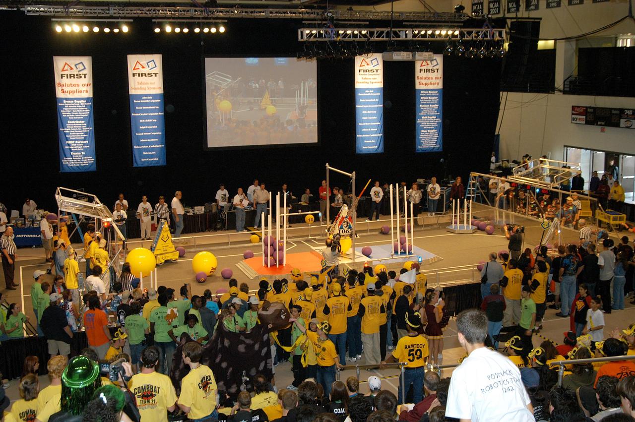 KENNEDY SPACE CENTER, FLA. -  In the University of Central Florida Arena, a local Central Florida team takes its turn during the 2004 Florida Regional FIRST competition. The event hosted 41 teams from Canada, Brazil, Great Britain and the United States.  Among observers at the annual event were Center Director Jim Kennedy and Florida Gov. Jeb Bush, who spoke at the event luncheon.  FIRST is a nonprofit organization, For Inspiration and Recognition of Science and Technology, that sponsors the event pitting gladiator robots against each other in an athletic-style competition. The FIRST robotics competition is designed to provide students with a hands-on, inside look at engineering and other professional careers, pairing high school students with engineer mentors and corporations.